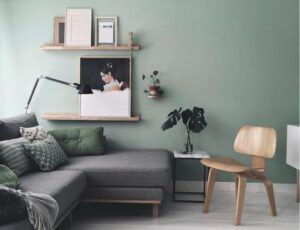 Gray couch with green wall